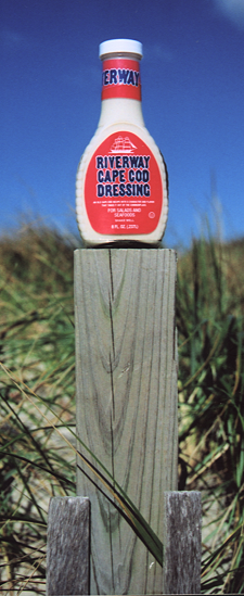 bottle of dressing on wood post.